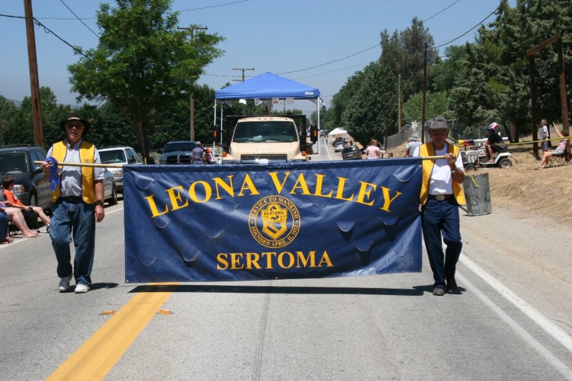 Leona Valley Parade proudly displaying banner.